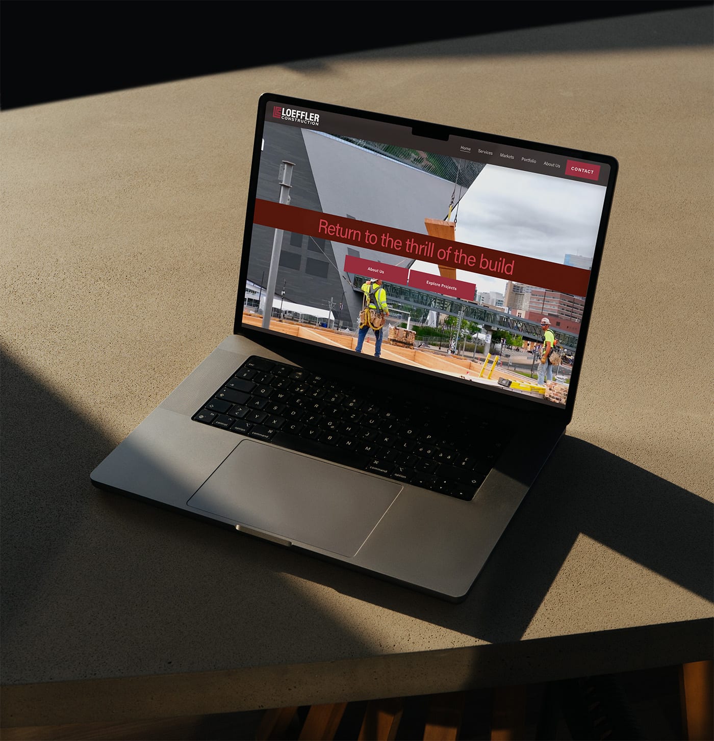 Loeffler Construction website homepage on a laptop with the headline Return to the thrill of the build