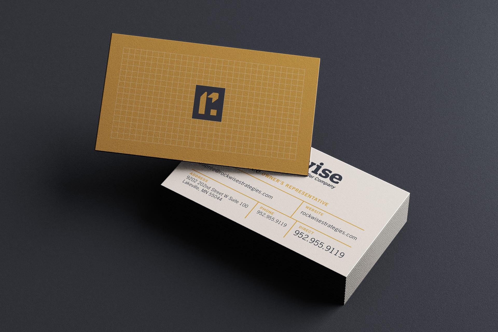 Rockwise business cards: gold grid pattern with the R mark on the front, contact details with a gold rule system on the back